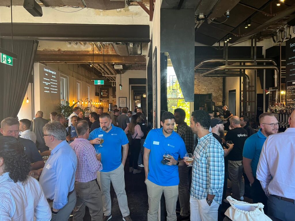Photo of a group of operational technology professionals gathering at a cyber security meetup in a bar setting